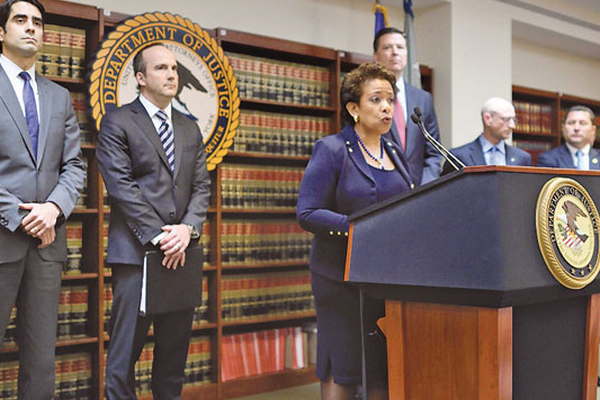 zzzzinte1US Attorney General Loretta E. Lynch announces charges against FIFA officials at a news conference on May 27, 2015 in New York. The soccer officials arrested on Wednesday in an investigation into the FIFA governing body have corrupted the international game, Lynch said Wednesday. She spoke after Swiss authorities acting on the US indictments detained several FIFA leaders in a dawn raid in Zurich as part of a corruption probe that has rocked the sport's governing body.  AFP PHOTO/DON EMMERT zzzz
